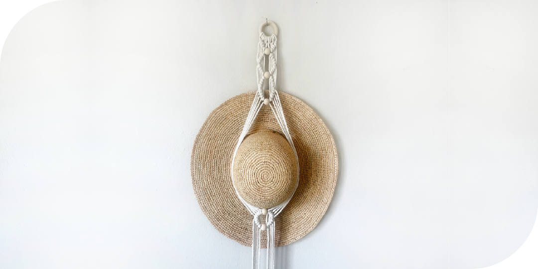 Macrame hat holder with a woven hat